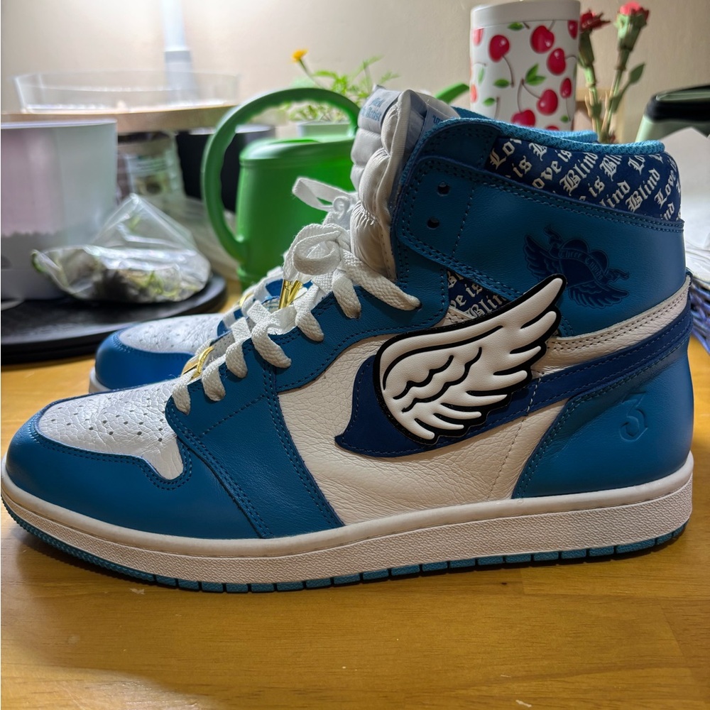 MELL THE ARTIST Blue and White High-Top Sneakers with Wing Design.